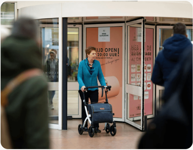 Senior exiting store with mobility aid