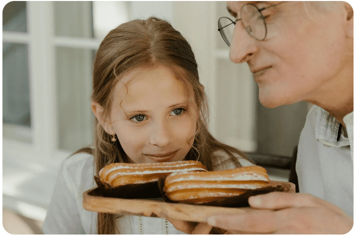 Child admiring tray of pastries