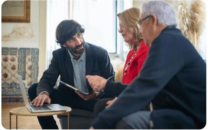 Business meeting with three people discussing