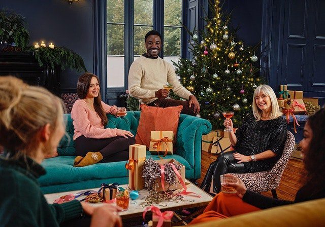 Friends celebrating Christmas in cozy living room